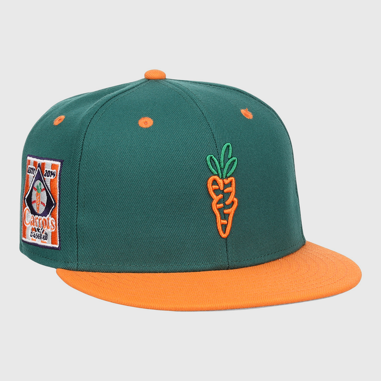 The EFF Carrots Arlington Heights Collection Logo Fitted Ballcap features green fabric, an orange brim and button, an embroidered orange carrot on the front, and a colorful side patch in the classic Ebbets Field Flannels style.