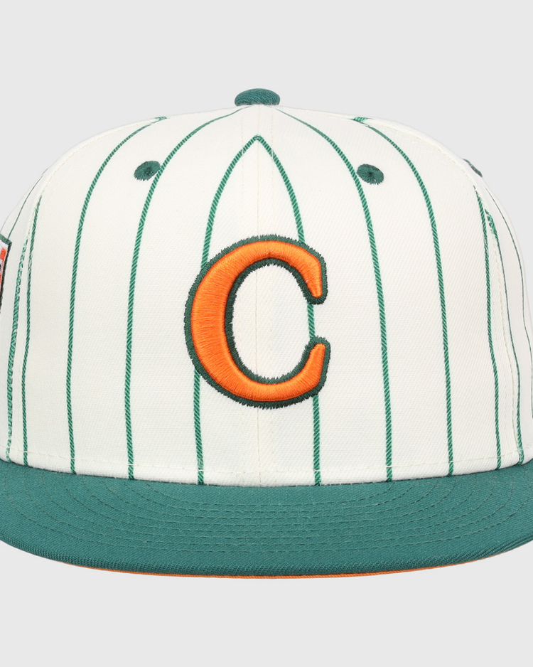 The EFF Carrots Arlington Heights Collection Pinstripe Fitted Ballcap features white fabric with green pinstripes, a green brim, and an orange C outlined in green, made in collaboration with Ebbets Field Flannels.