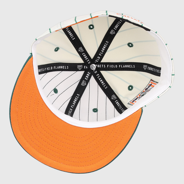 Interior view of the Carrots Arlington Heights Collection Pinstripe Fitted Ballcap by EFF, featuring orange brim stitching, green stripes and vents, plus black bands with the “EBBETS FIELD FLANNELS” logo from a brand collaboration.