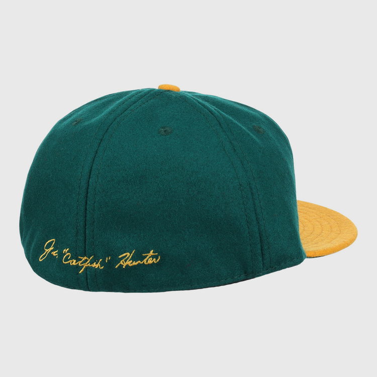 The Catfish Hunter Signature Series Ballcap by Ebbets Field Flannels features green vintage wool, a yellow brim and button, and gold J.G. Catfish Hunter embroidery—perfect for National Baseball Hall of Fame fans.