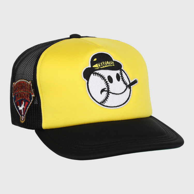 The Charleston Charlies MiLB Vintage Foam Trucker Ballcap by Ebbets Field features a yellow and black design with a smiling baseball face on front and a Venezuelan Professional Baseball League patch on the mesh side panel.