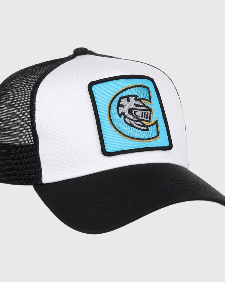 The Ebbets Field Charlotte Knights MiLB Trucker Ballcap is black and white with a curved bill, mesh back, and features a blue patch on the front showing a stylized fish logo inside the letter C.
