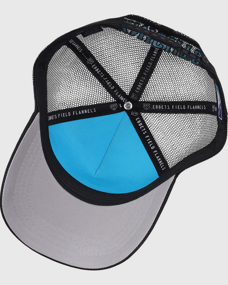 A look inside the Charlotte Knights MiLB Trucker Ballcap by Ebbets Field, featuring a black mesh design, gray brim, blue inner panel, and black support bands labeled EBBETS FIELD.