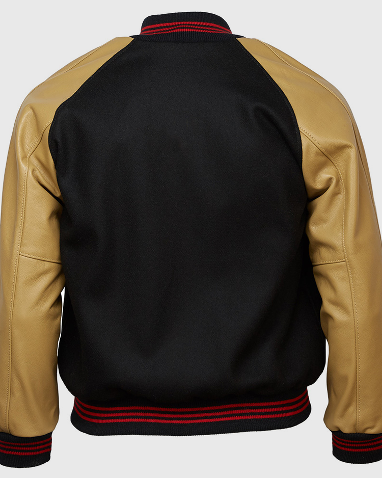 The EFF Chicago American Giants 1936 Authentic Jacket is a black Negro League varsity jacket with tan leather sleeves, black collar, and black waistband and cuffs with red stripes, shown from the back.
