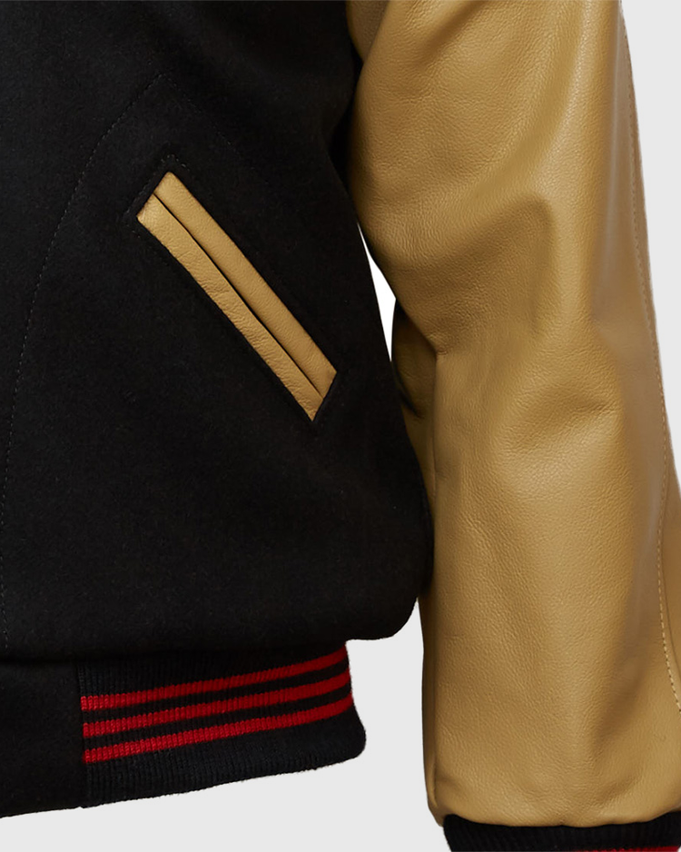 Close-up of the EFF Chicago American Giants 1936 Authentic Jacket: black body, tan leather sleeve, tan-trimmed pocket, and a black ribbed waistband with red stripes inspired by the classic 1936 style.