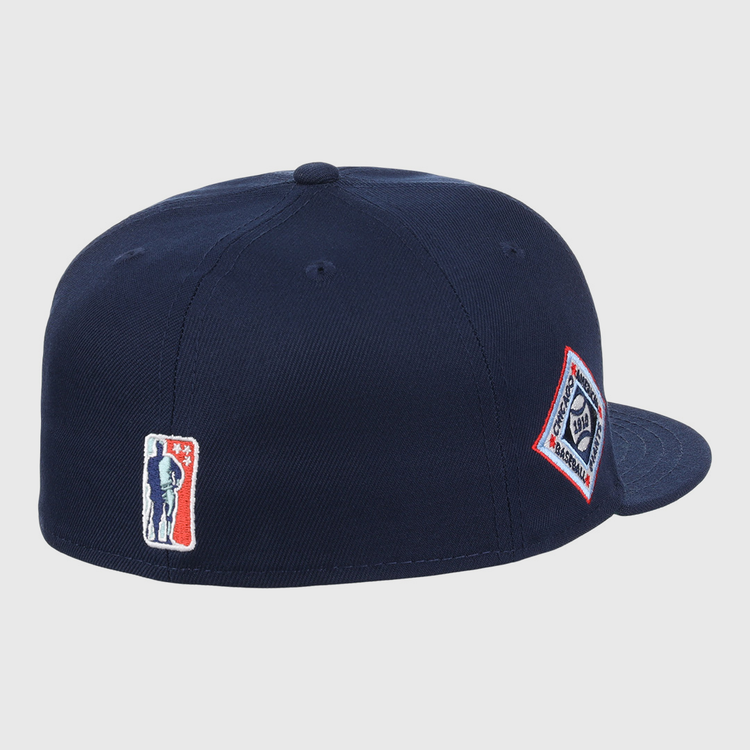 The EFF Chicago American Giants NLB Team Color Fitted Ballcap is a navy blue crown cap with a flat brim, featuring a silhouette logo patch on the back and a diamond-shaped text logo patch on the side, inspired by vintage NLB Flip styles.