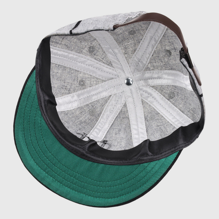 A close-up view of the inside of the Ebbets Field Chicago Union Giants NLB 1905 Vintage 8-Panel Ballcap, highlighting its green brim, stitching details, metal top button, and sweatband.