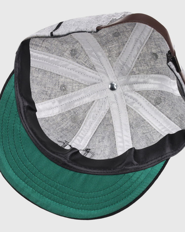 A close-up view of the inside of the Ebbets Field Chicago Union Giants NLB 1905 Vintage 8-Panel Ballcap, highlighting its green brim, stitching details, metal top button, and sweatband.