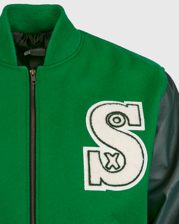 The EFF Chicago White Sox 1932 Authentic Jacket features kelly green wool, black leather sleeves, a black zipper, and a bold white “S” patch outlined in black on the left chest—evoking vintage varsity style.