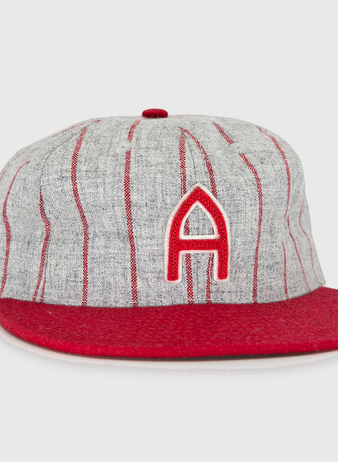 The Club Artemisa 1943 Vintage Ballcap by Ebbets Field Flannels features genuine grey wool, thin red stripes, a red brim, and a bold red A on the front, inspired by the Cuban National Amateur League team.