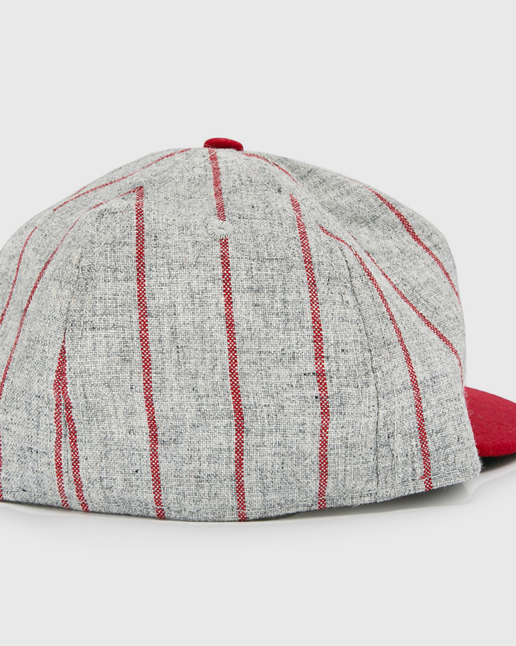 The Club Artemisa 1943 Vintage Ballcap by Ebbets Field Flannels features gray wool with vertical red stripes, a solid red brim, and a classic back view inspired by the Cuban National Amateur League.