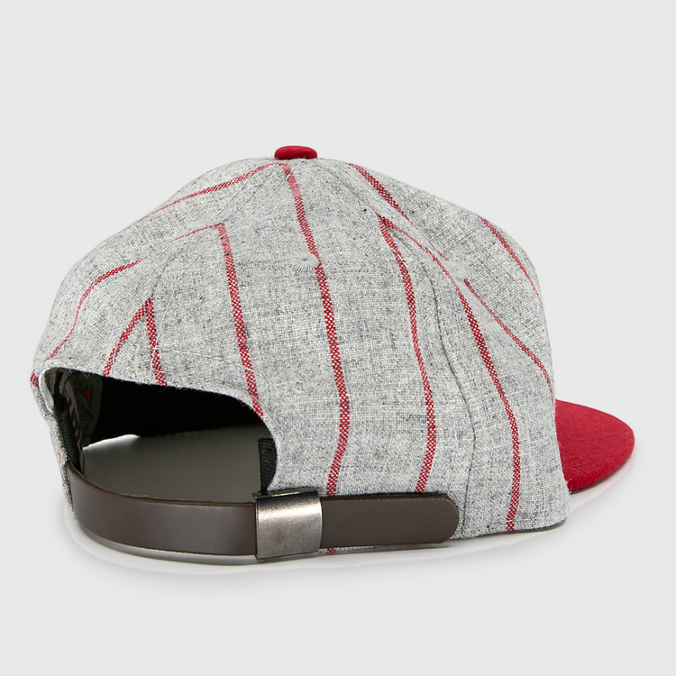 The Ebbets Field Flannels Club Artemisa 1943 Vintage Ballcap, made of genuine wool, features a bold red brim, grey panels with red stripes, and a brown adjustable strap with metal buckle—shown from the back.