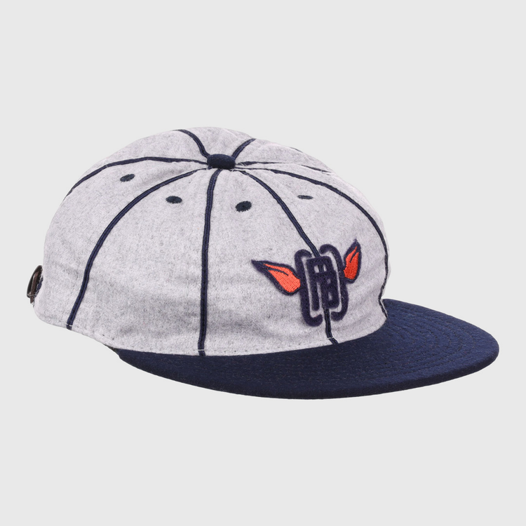 The EFF Columbia Park 1909 Vintage 8-Panel Ballcap is a gray cap with a navy visor and seams, featuring an embroidered blue letters and red wings logo on the front, inspired by classic Columbia Park Boys Club style.