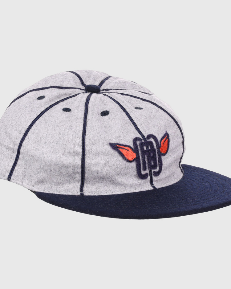 The EFF Columbia Park 1909 Vintage 8-Panel Ballcap is a gray cap with a navy visor and seams, featuring an embroidered blue letters and red wings logo on the front, inspired by classic Columbia Park Boys Club style.