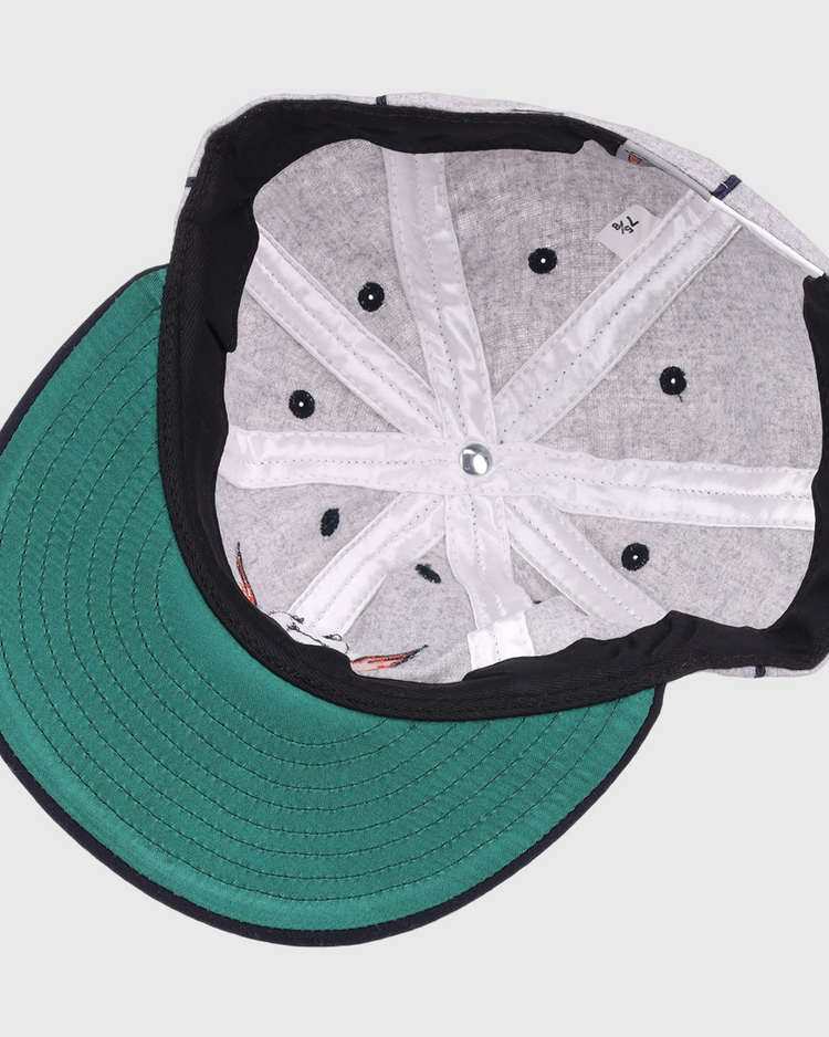 The image shows the inside of an EFF Columbia Park 1909 Vintage 8-Panel Ballcap with a green brim, gray lining, black sweatband, visible stitching, and ventilation holes. The cap is laid flat with the brim facing left.