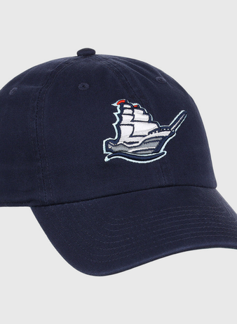 The Ebbets Field Columbus Clippers MiLB Dad Ballcap is a navy blue cap with an embroidered white sailing ship and red flags on the front panel.