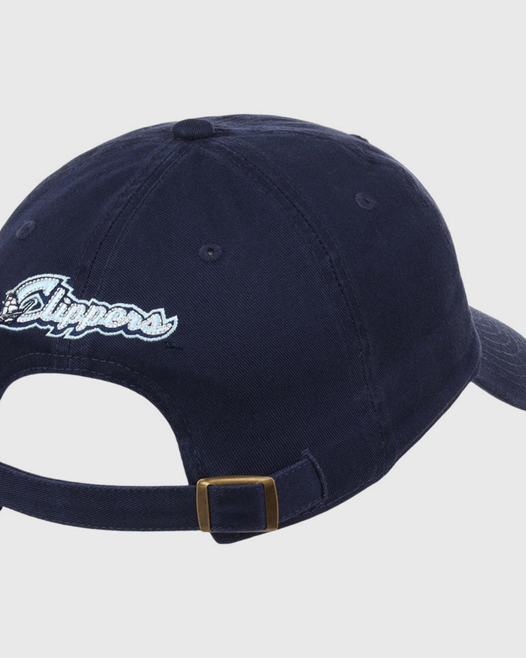 The Ebbets Field Columbus Clippers MiLB Dad Ballcap is a navy baseball cap featuring an adjustable strap with brass buckle and 