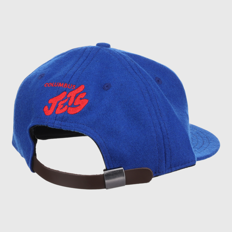 The EFF Columbus Jets Letterhead Wool Vintage Ballcap is a blue Minor League hat viewed from the back, featuring red embroidered COLUMBUS JETS text and a brown adjustable strap with metal clasp.