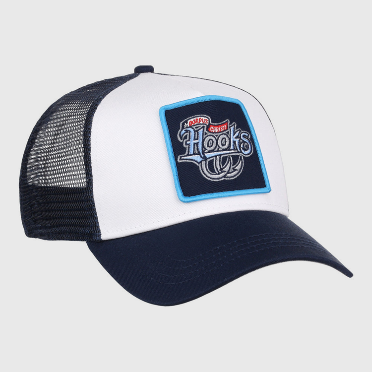 The Ebbets Field Corpus Christi Hooks MiLB Trucker Ballcap is a white and navy mesh-back hat featuring a front patch with “Hooks,” a fishing hook graphic, and the phrase “No Bad Days, Just Cast” above it.