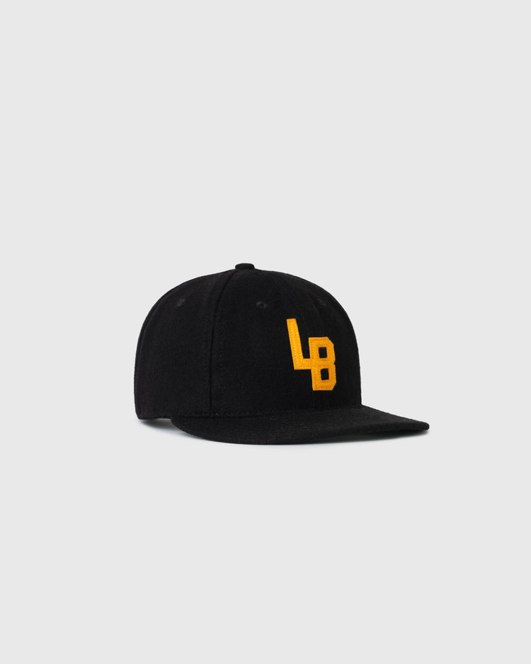 The EFF Cal State Long Beach 1961 Authentic Wool Ballcap is a black, flat-brim cap with yellow embroidered LB letters on the front, displayed against a plain light gray background.
