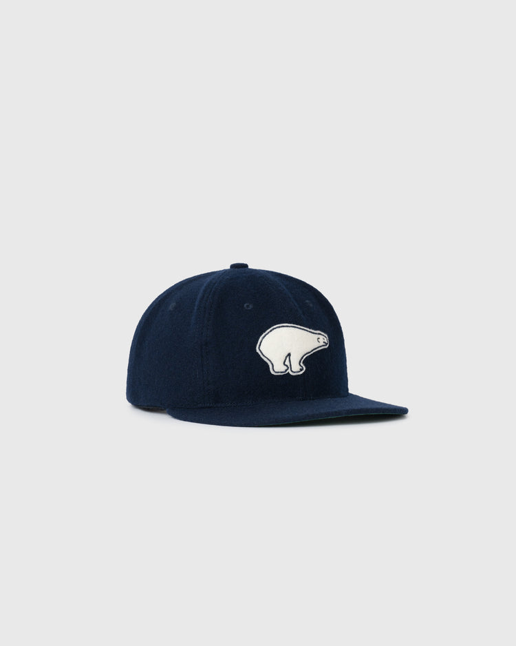 The EFF Cerveceria Polar 1950 Authentic Wool Ballcap, a navy vintage baseball hat featuring a white Cuban Polar Bear mascot patch on the front, is shown against a plain light gray background.