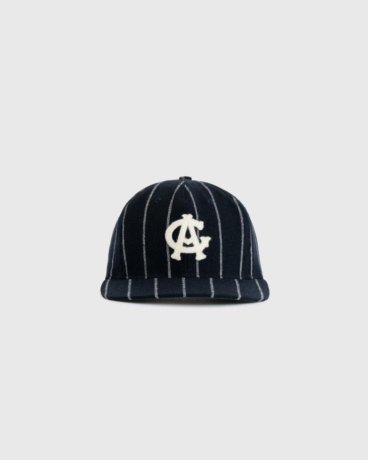 The EFF Chicago American Giants 1926 Vintage Ballcap features navy blue wool, white vertical pinstripes, and a bold white overlapping CA logo on the front, inspired by the original 1926 design and shown on a plain light gray background.