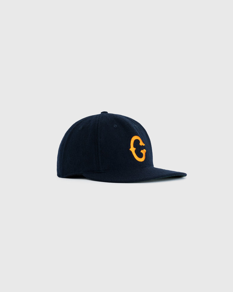 The EFF Clemson University 1963 Authentic Wool Ballcap is navy blue with a flat brim and a yellow C on the front, shown against a plain light gray background.