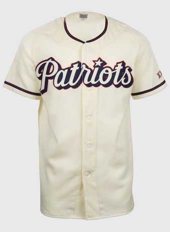 The EFF Dallas Baptist University Home Jersey is cream-colored with black and red trim, Patriots in large script on the chest, a flannel-style design, front buttons, and short sleeves.