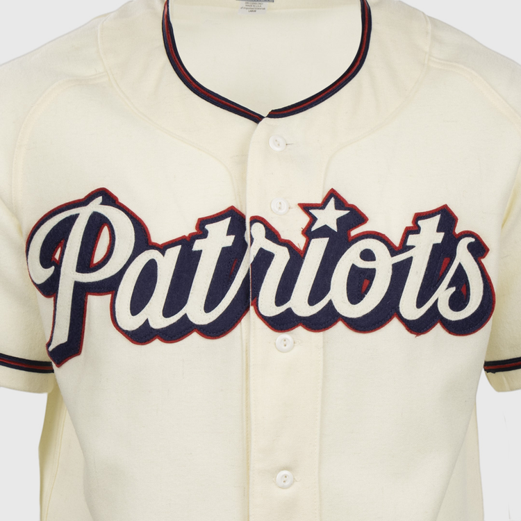 The EFF Dallas Baptist University Home Jersey is a cream Patriots baseball shirt with bold navy script, red outline, and a star over the i, inspired by the classic DBU jersey style.