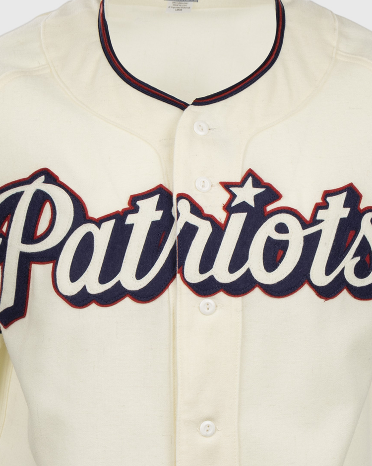 The EFF Dallas Baptist University Home Jersey is a cream Patriots baseball shirt with bold navy script, red outline, and a star over the i, inspired by the classic DBU jersey style.