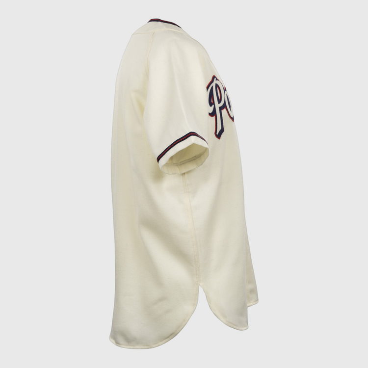 The EFF Dallas Baptist University Home Jersey is shown from the side in cream, with dark sleeve trim and partial lettering across the chest.