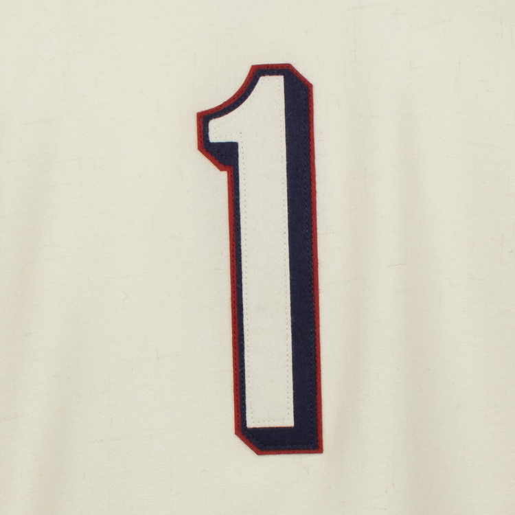 A large, bold white number 1 with dark blue and red outline stands centered on cream fabric, echoing the classic Dallas Baptist University Home Jersey by EFF.