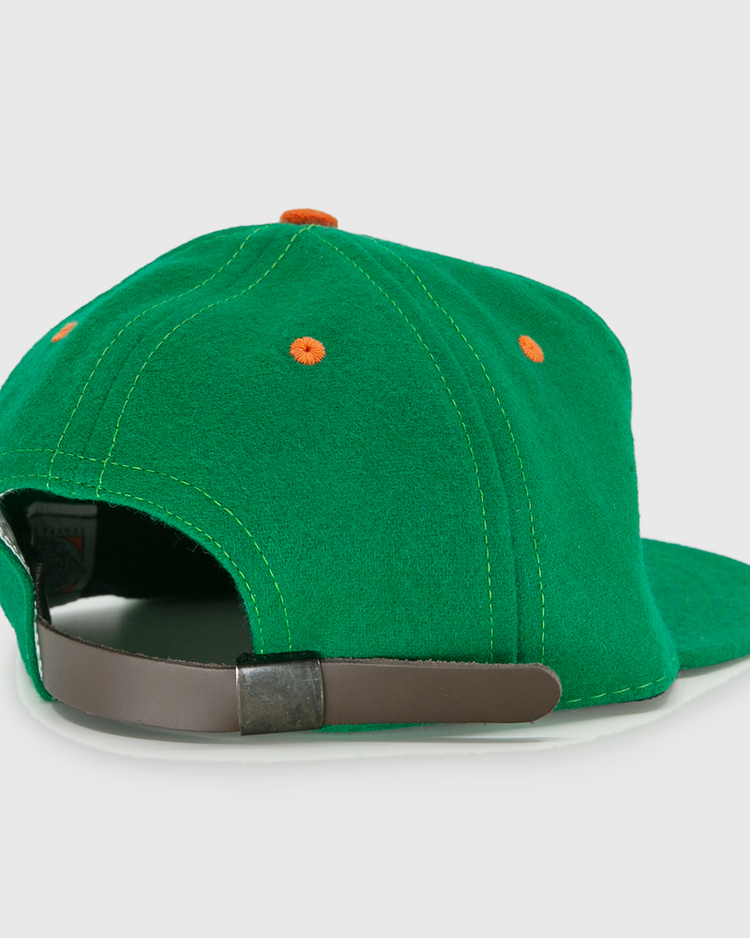 The EFF Dublin Green Sox 1951 Vintage Ballcap features orange eyelets and a brown adjustable strap with metal buckle, delivering retro style from the back view.