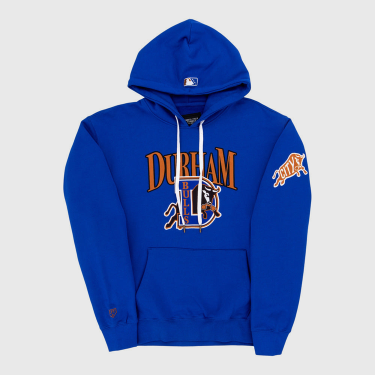 The Durham Bulls MiLB Cotton Hooded Sweatshirt by Ebbets Field features DURHAM BULLS and a bull logo on the front, an orange CITY patch on the sleeve, kangaroo pocket, drawstrings, and an MLB logo on the hood.