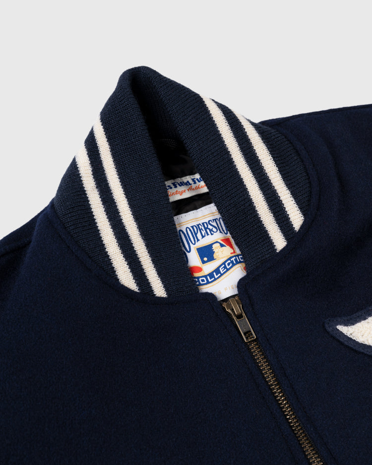 Close-up of an EFF Detroit Tigers 1955 Authentic Wool & Leather Varsity Jacket in navy, featuring a striped ribbed collar, vintage patch details, and a Cooperstown Collection label.