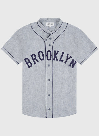 Crafted by Ebbets Field, the Brooklyn Eagles 1935 Authentic Wool Road Jersey features a gray short-sleeve button-up design with black piping and bold black “BROOKLYN” lettering across the chest, faithfully reproducing the classic Negro Leagues style—an ideal piece for any baseball enthusiast.