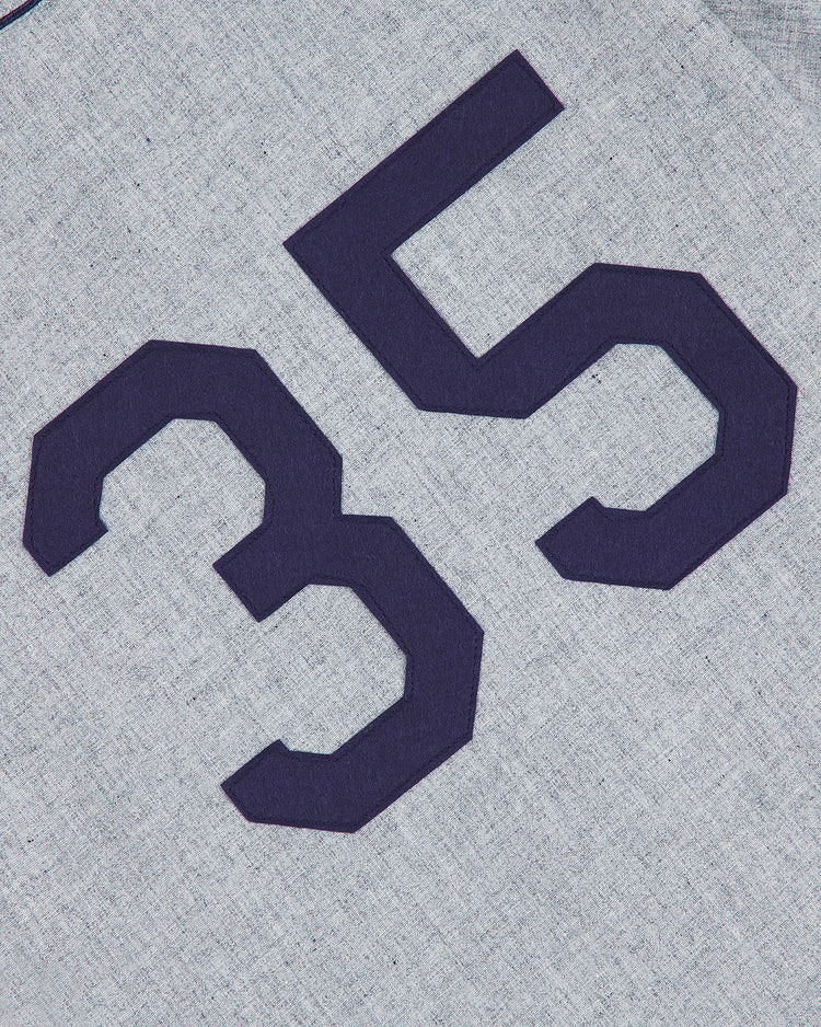 A close-up of the Ebbets Field Brooklyn Eagles 1935 Authentic Wool Road Jersey, featuring gray wool fabric with large, dark blue block-style number 35—reminiscent of a classic Negro Leagues reproduction.