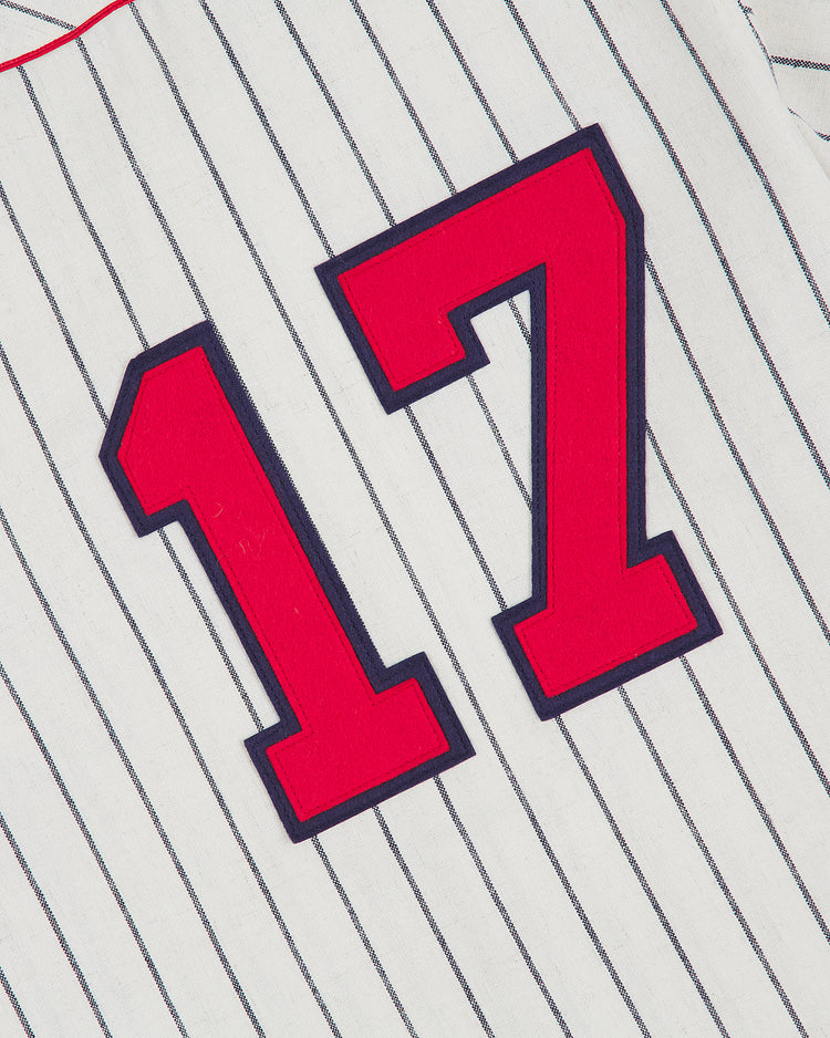 A white, vertically pinstriped wool baseball jersey by Ebbets Field, featuring a red number 17 and styled after the authentic 1935 New York Cubans Negro League road jersey.