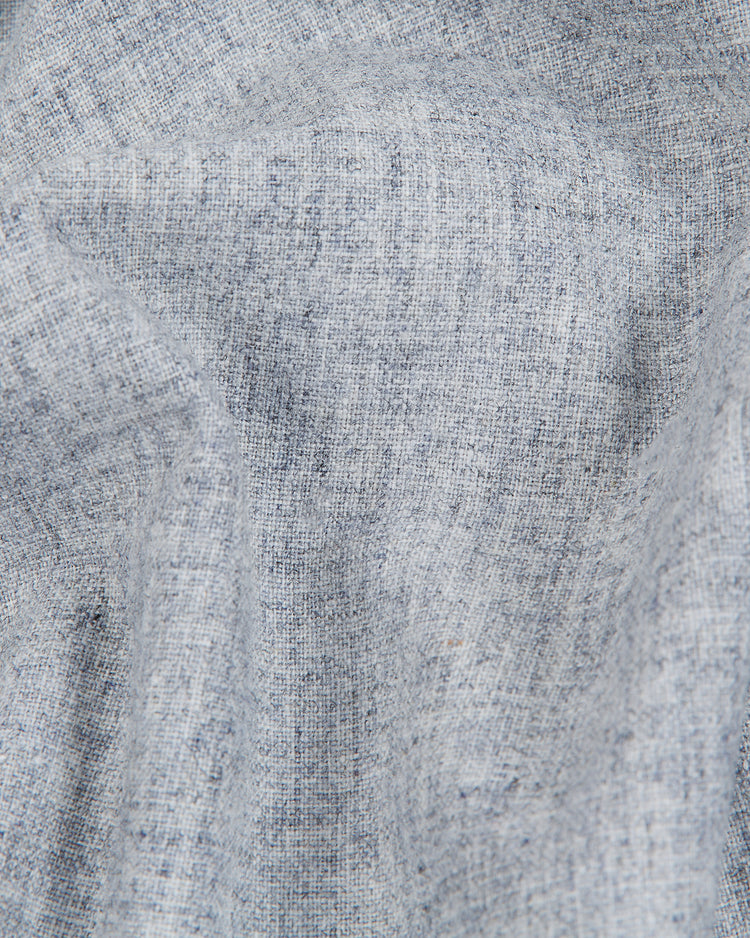 Close-up of light gray wool fabric with a subtle woven texture and fine visible threads, recalling the vintage charm of an early baseball jersey. The gentle folds and natural creases highlight the authentic look and feel of the Ebbets Field Brooklyn Royal Giants 1915 Authentic Wool Road Jersey.