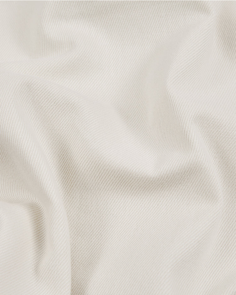 Close-up of the Ebbets Field Brooklyn Royal Giants 1919 Cotton Twill Baseball Jersey, showcasing its white textured fabric with subtle diagonal lines and soft folds that create gentle shadows and highlights—evoking the timeless design of the historic jersey worn by the legendary team in 1919.