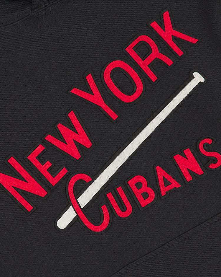 Crafted by Ebbets Field, the New York Cubans Heavyweight Cotton Terry Pullover Hoodie features black fabric with “NEW YORK CUBANS” in bold red lettering. A white baseball bat graphic runs diagonally through “CUBANS,” capturing a classic style inspired by Negro League apparel and honoring the legendary New York Cubans team.
