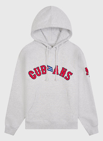 Introducing the New York Cubans Heavyweight Cotton Terry Pullover Flag Hoodie by Ebbets Field—a light gray, heavyweight cotton hoodie showcasing bold red “CUBANS” lettering and a small Cuban flag on the chest. Inspired by classic Negro League apparel, this hoodie also features a distinctive red patch on the left sleeve, drawstrings, and a convenient front pocket.
