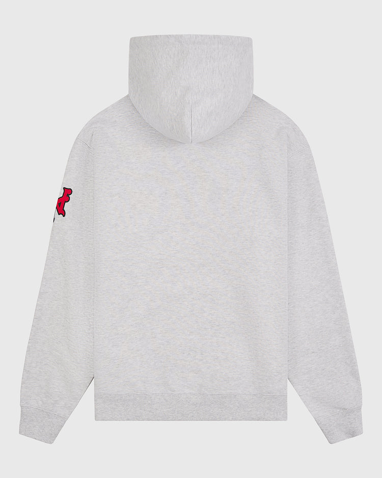 A light gray New York Cubans Heavyweight Cotton Terry Pullover Flag Hoodie by Ebbets Field, shown from the back, features a small red and black bear patch on the left sleeve. Inspired by classic Negro League apparel, this plain hoodie has no visible designs or text on the back.
