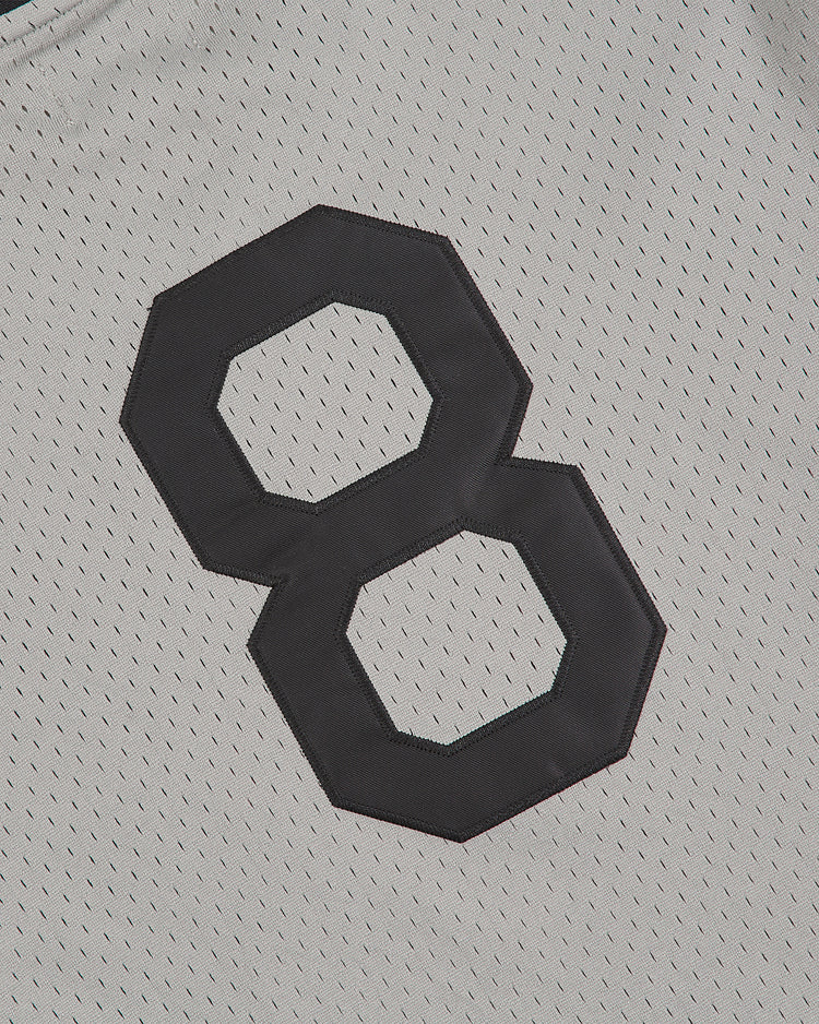 A close-up of the Ebbets Field Baltimore Elite Giants 1949 V-Neck Mesh Road Jersey, showcasing a large black number 8 stitched onto the white fabric.