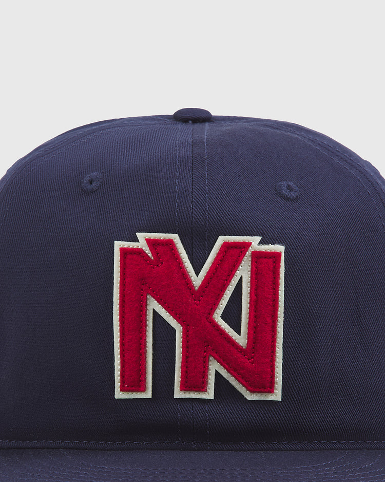The Ebbets Field Brooklyn Eagles Cotton Twill Ballcap is a navy blue baseball cap featuring a bold red and white embroidered logo with interlocking letters on the front.