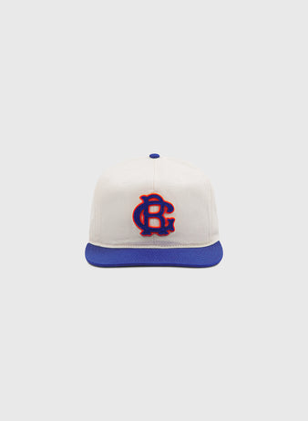 The Brooklyn Royal Giants Cotton Twill Ballcap by Ebbets Field features a white cotton twill crown, a blue brim, and a red and blue embroidered “CB” logo on the front. Displayed against a plain light gray background, this cap honors Black baseball history and celebrates iconic teams such as the Brooklyn Royal Giants.