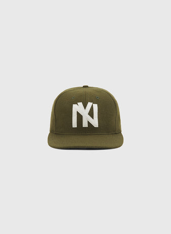 The Brooklyn Eagles 1935 Wool Ballcap by Ebbets Field is crafted from olive green wool, features a flat brim and a bold white interlocking NY logo embroidered on the front, and is photographed against a plain light background—evoking the classic style of the 1935 Negro Leagues team.
