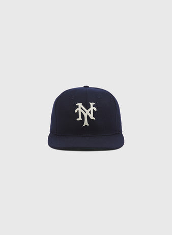 The Ebbets Field New York Cubans Authentic Wool Ballcap, featuring a navy blue wool construction and a white interlocking NY logo inspired by the styles worn by Negro National League teams like the New York Cubans, is displayed against a plain light gray background.
