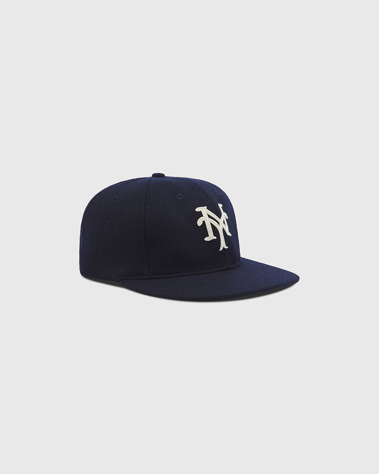 The Ebbets Field New York Cubans Authentic Wool Ballcap, crafted in navy blue wool and showcasing a white NY logo on the front inspired by the New York Cubans of the Negro National League, is displayed against a plain light gray background.