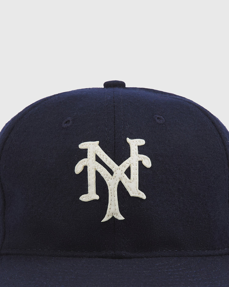 The Ebbets Field New York Cubans Authentic Wool Ballcap Navy is a navy blue baseball cap featuring a white, interlocking NY logo on the front.